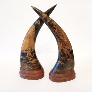 Pair of vintage chinoiserie carved buffalo horns circa 1950 horns with carved flying eagles and wooden base oriental carved horn Asian decor