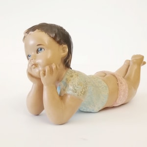 Ceramic figurine of little boy laying down circa 1950 vintage ceramic boy with blue glass eyes from Spain