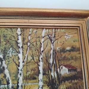 May include: A framed painting depicting a forest scene with birch trees, a small house, and a stream. The painting is done in a realistic style with muted colors.