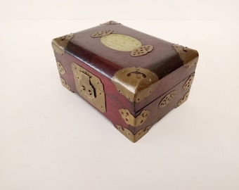 Chinese wood jewellery box with central pale green carved jade medallion decorated with etched brass circa 1970