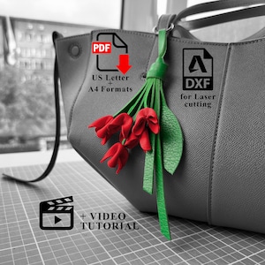 May include: A grey leather handbag adorned with a decorative leather flower charm featuring three red tulip-shaped blossoms and two green leaves. The image includes text overlays indicating PDF US Letter and A4 formats, DXF for laser cutting, and a video tutorial.