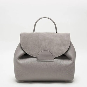 May include: A gray leather backpack with a suede flap and a top handle.
