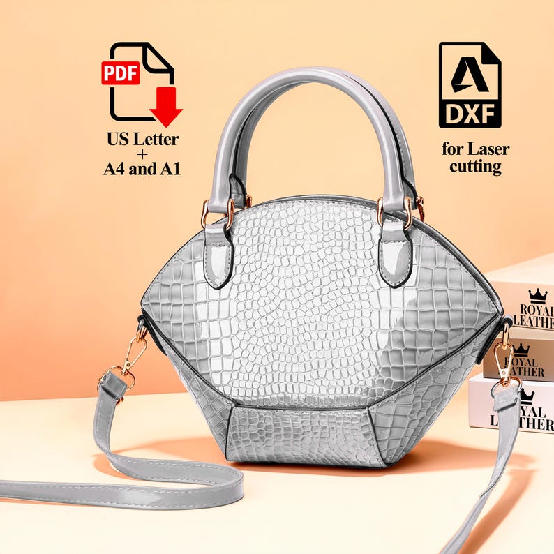 Peut inclure: Un sac &agrave; main argent&eacute; avec un motif crocodile, dot&eacute; d'une poign&eacute;e sup&eacute;rieure et d'une bandouli&egrave;re amovible. Le sac a une quincaillerie dor&eacute;e et le texte "DXF for Laser cutting" et "US Letter + A4 and A1".