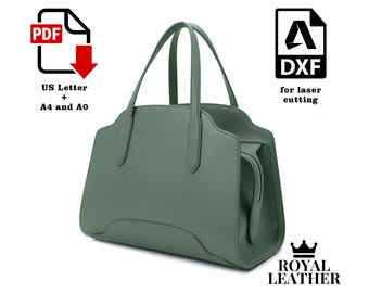 May include: A green leather tote bag with a top handle and a zipper closure. The bag is labeled "ROYAL LEATHER".