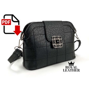 May include: Black quilted crossbody bag with a silver clasp adorned with black jewels. The bag has a long adjustable strap and the brand name "ROYAL LEATHER" is printed on the bottom right corner.