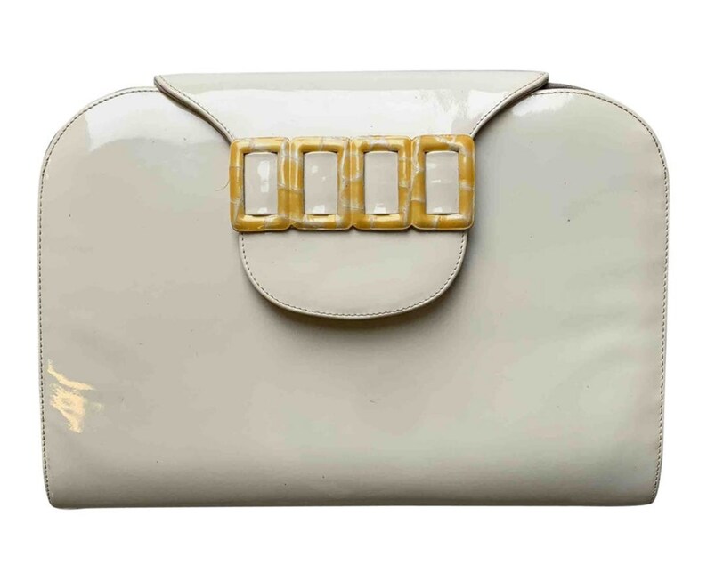 cream patent clutch bag