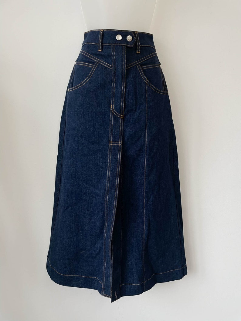 ELLERY mid length denim skirt with unusual panelled construction. High waisted, with zipper and statement poppers at the front. made from thick, high quality selvedge denim.