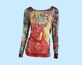 May include: A long-sleeved top with a vibrant, abstract print in shades of red, yellow, green, and brown. The scoop-neck shirt has a fitted silhouette and is made of a sheer material. The sleeves are long and fitted, and the overall design is artistic.