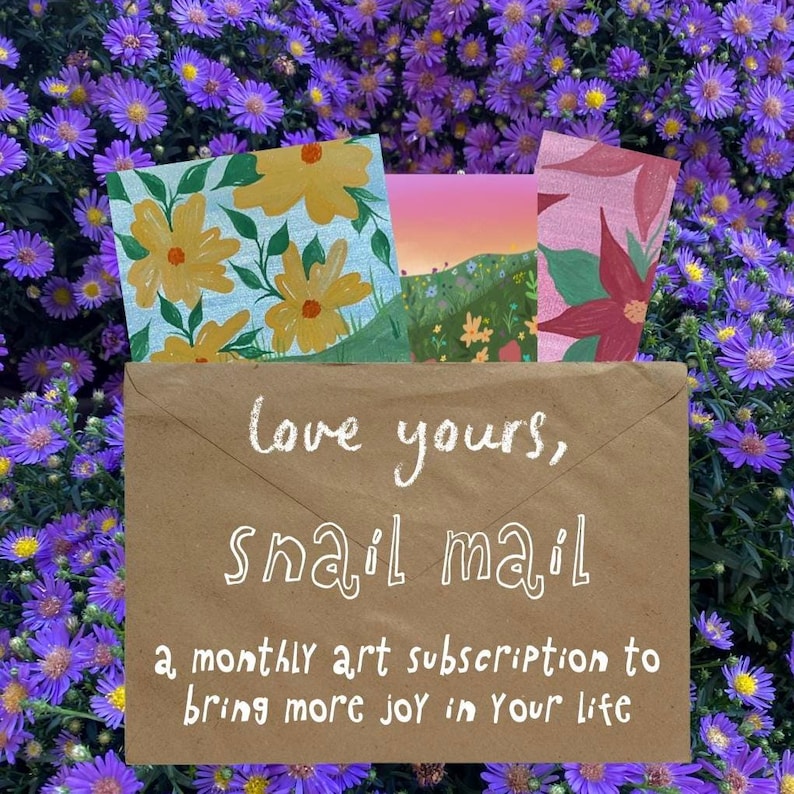 May include: A brown paper envelope with the white text "love yours, snail mail a monthly art subscription to bring more joy in your life" printed on the front. Three colorful illustrated cards with floral and landscape designs peek out.
