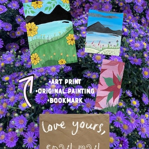 May include: An art print, an original painting, and a bookmark featuring landscape illustrations, accompanied by a brown envelope with the white handwritten text "love yours, snail mail" and a pink arrow pointing toward the art items.