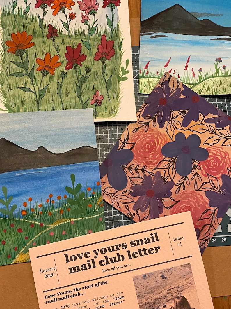 May include: A collection of four illustrated cards and a newsletter titled love yours snail mail club letter issue #1 dated January 2026. The artwork features vibrant floral meadows, a blue lake with dark mountains, and a pattern of purple and pink flowers.