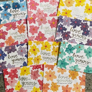 May include: A collection of ten rectangular envelopes featuring various floral patterns in shades of blue, pink, yellow, purple, teal, and orange. Each envelope displays the handwritten text "love yours snail-mail club" in a cursive script.