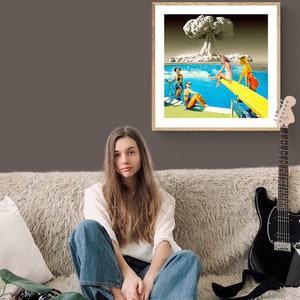 May include: A framed collage of a mushroom cloud explosion over a swimming pool with women in bathing suits. The women are sitting on the edge of the pool and on a diving board.