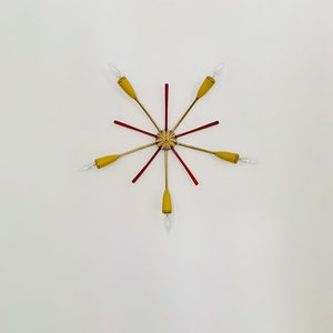 May include: A gold and red starburst ceiling light fixture with six arms and six light bulbs.