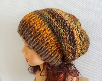 May include: A brown, orange, and green knit beanie hat. The hat is slouchy and has a loose fit.