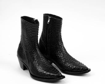 May include: A pair of black snakeskin ankle boots with pointed toes and a zipper on the back of each boot.