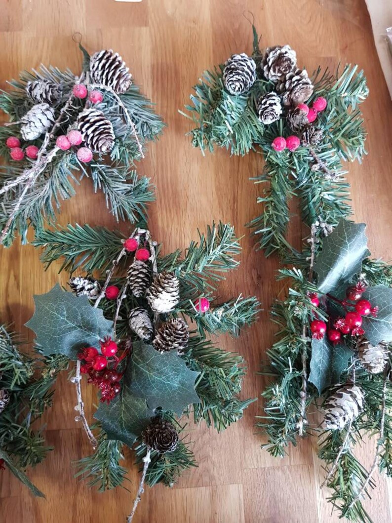 One branch hangers with berries and pine cones.