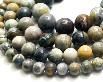 May include: Strands of gemstone beads in various sizes and shades of green, gray, brown, and cream. The beads are round and have a polished finish. The beads are strung together, ready for jewelry making. The beads are on a white background.