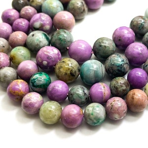 May include: A strand of purple, green, and brown gemstone beads. The beads are round and have a mottled appearance.