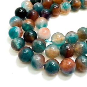 May include: A strand of round, multi-colored agate beads. The beads are a mix of green, brown, and white.