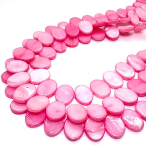 May include: Strands of pink oval-shaped beads. The beads have a glossy finish and vary in shades of pink, from light to deep rose. The beads are strung together, creating a flowing, organic shape. The background is white.