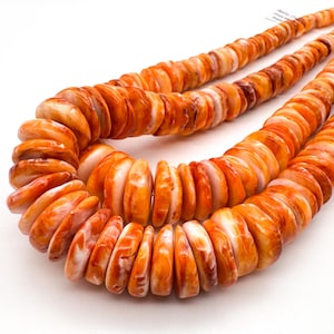 May include: Three strands of orange and white shell necklaces. The necklaces are made of flat, round shell beads, each with a unique pattern of orange and white hues. The beads are strung together, creating a layered effect.