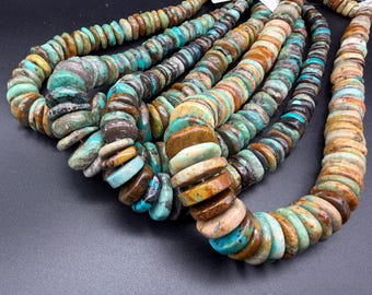 May include: A collection of multi-strand necklaces featuring flat, round, disc-shaped beads in various shades of turquoise, tan, brown, and cream. The beads exhibit natural color variations and textures, arranged in several parallel strands.