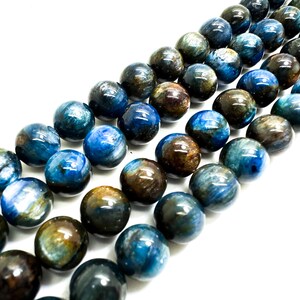 May include: A strand of blue and brown gemstone beads. The beads are round and have a smooth, polished finish.