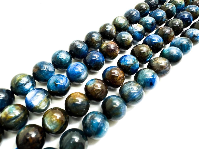 May include: A strand of blue and brown gemstone beads. The beads are round and have a smooth, polished finish.