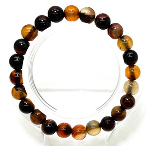 May include: A brown, black, and orange agate gemstone bracelet with round beads.