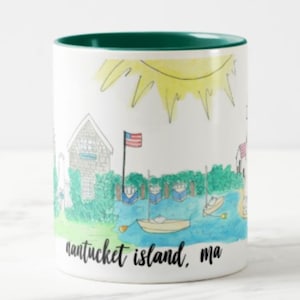 May include: White ceramic coffee mug with a green rim. The mug features a hand-drawn illustration of a sunny day in Nantucket, Massachusetts. The illustration includes a house, a flag, boats, and the text "nantucket island, ma".