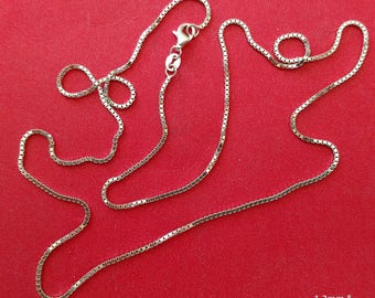 May include: A silver chain necklace with a box chain design. The chain is 1.2 mm wide.
