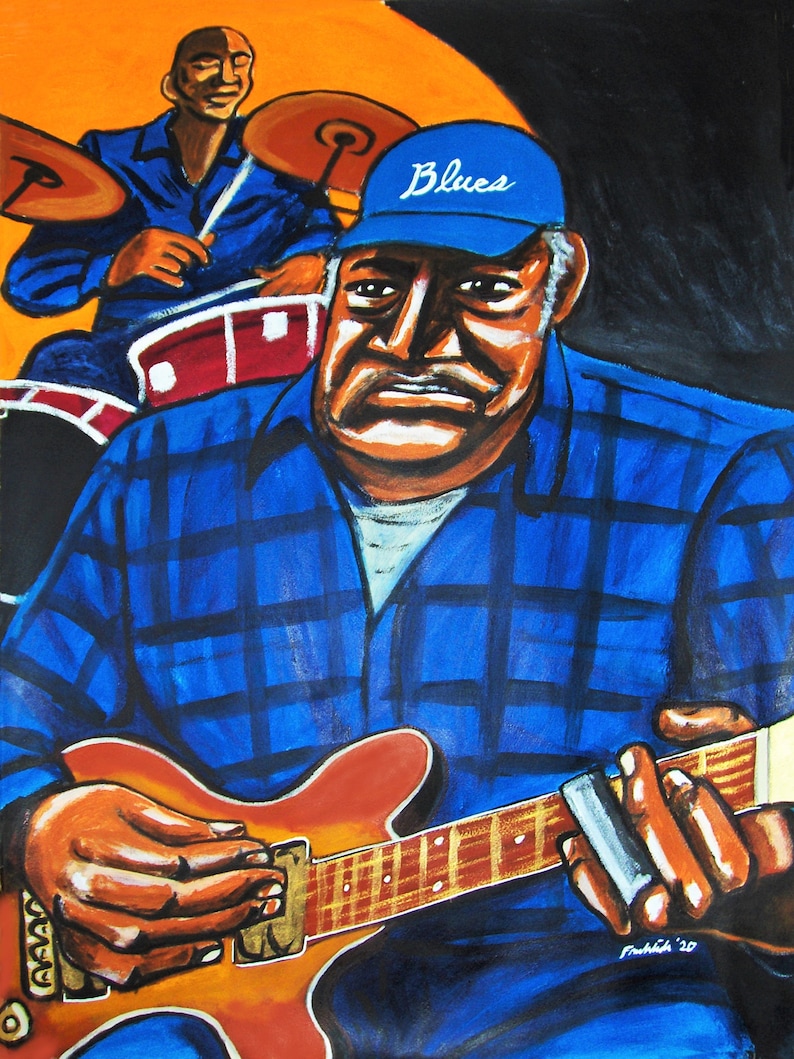 May include: A man wearing a blue plaid shirt and a blue baseball cap with the word "Blues" on it plays a red electric guitar with a slide. He is sitting in front of a drum set with a drummer in the background.