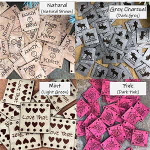 May include: A collection of square labels in four colors: natural brown with Piggy Knitty text, dark grey with Northern Craftster moose graphics, light green with Love That heart patterns, and dark pink with heart designs, all featuring corner holes.