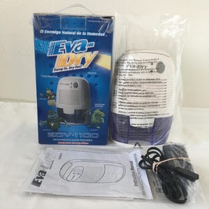 May include: An Eva-Dry EDV-1100 electric petite dehumidifier, with its box and instruction manual. The box is blue with the text "Eva-Dry" and "Damp In. Dry Out!". The dehumidifier is white and blue, and the instruction manual is white.