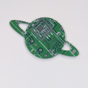 May include: Green circuit board with a ring shape and the text "J1", "C", "C96", "C97", "L35", "R92", "R182", "R1830", "R184", "C980", "R1010", "R94", "HB5", "014", and "W25" printed on it.