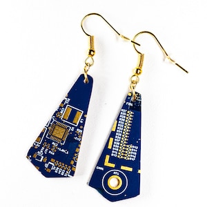 May include: A pair of blue and gold earrings made from recycled circuit boards. The earrings are shaped like triangles and have gold hooks.