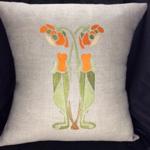 May include: A decorative pillow with an embroidered design of stylized orange flowers with green leaves on a light gray linen fabric.