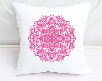 May include: A white pillow with a pink mandala design. The mandala is intricate and detailed, with a floral pattern.