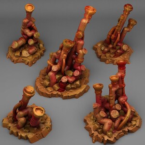 May include: Five miniature, hand-painted, rusty-orange metal pipe structures on brown, rocky bases. The pipes are arranged in different configurations, creating unique and intricate designs.
