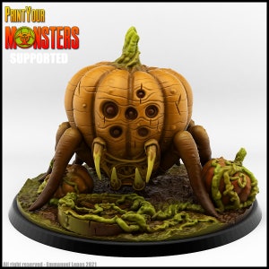 May include: A 3D printed pumpkin-shaped spider monster with multiple eyes and spindly legs. The monster is painted in shades of brown and green and is standing on a circular base with green vines. The text "Print Your Monsters Supported" is visible in the top left corner of the image.