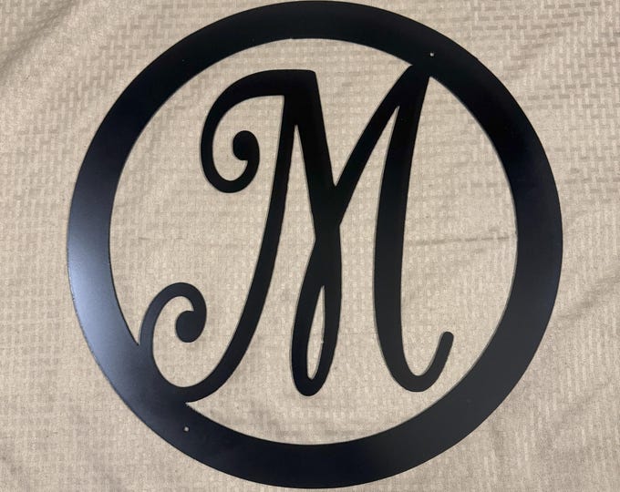 Metal letter M with circle