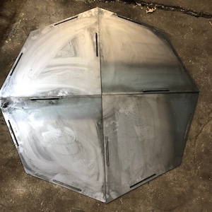 Fire pit bottoms cut from 14 gauge steel. Interlocking design. Available in high temp black or bare metal.