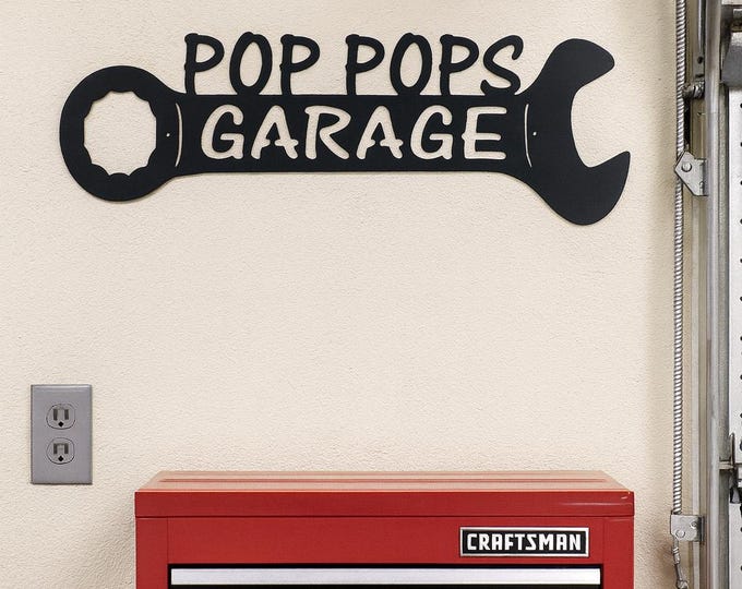 Metal pop pops garage wrench sign.