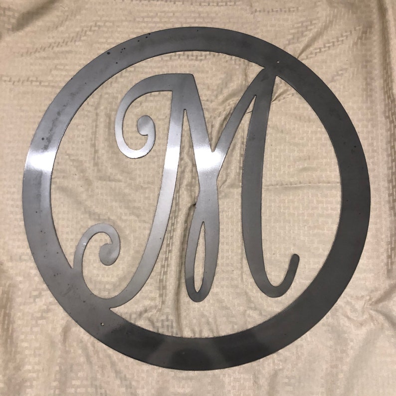 Metal letter M with circle