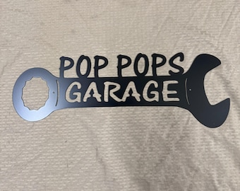 Metal pop pops garage wrench sign.