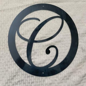 Metal letter C in circle