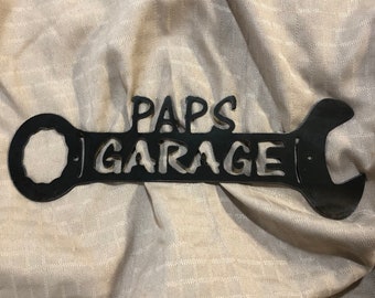 Metal paps garage wrench sign.