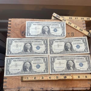 Vintage lot of 5 silver certificates 1957 and 4 series A circulated in protective sleeves