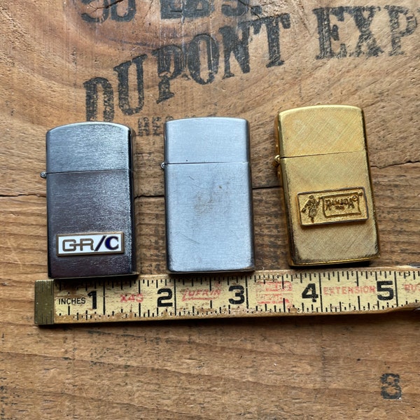 Lot of 3 slim lighters Howard, Impact 14K gold plate, and Golden Bell advertising all spark usable